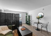Thumbnail 7 of 11 - a living room with a table and chairs and